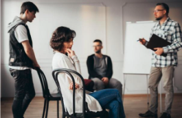 Woman looking distracted and lost in thought during a group discussion